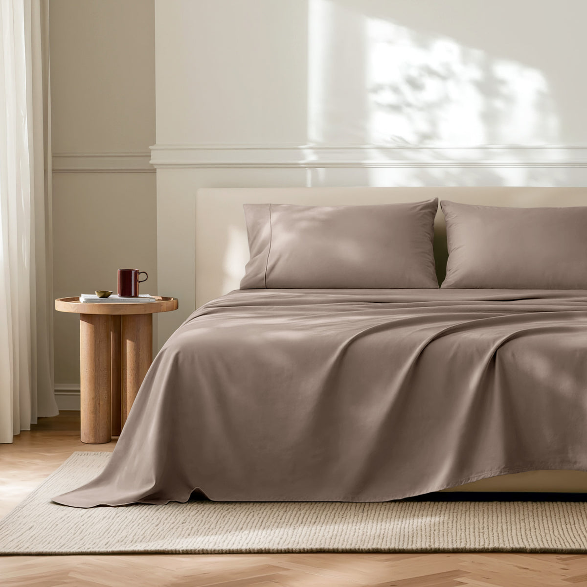 Neatly made bed with microfiber bedding in a bright bedroom.