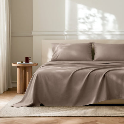 Neatly made bed with microfiber bedding in a bright bedroom.
