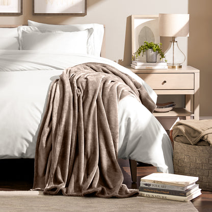 Microplush blanket draped over the corner of a bed