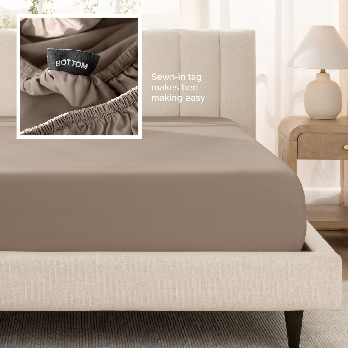 Sateen fitted sheet on a bed with a close-up of a sewn-in tag, set in a bedroom.