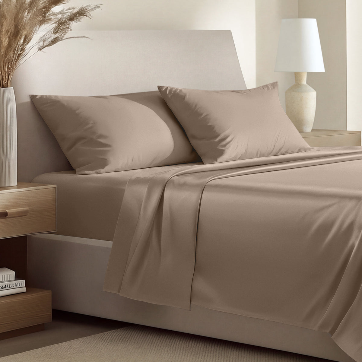 Sateen bedding set including a fitted sheet and two matching pillowcases on a bed.