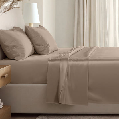 Sateen sheet set on a bed in a softly lit bedroom.