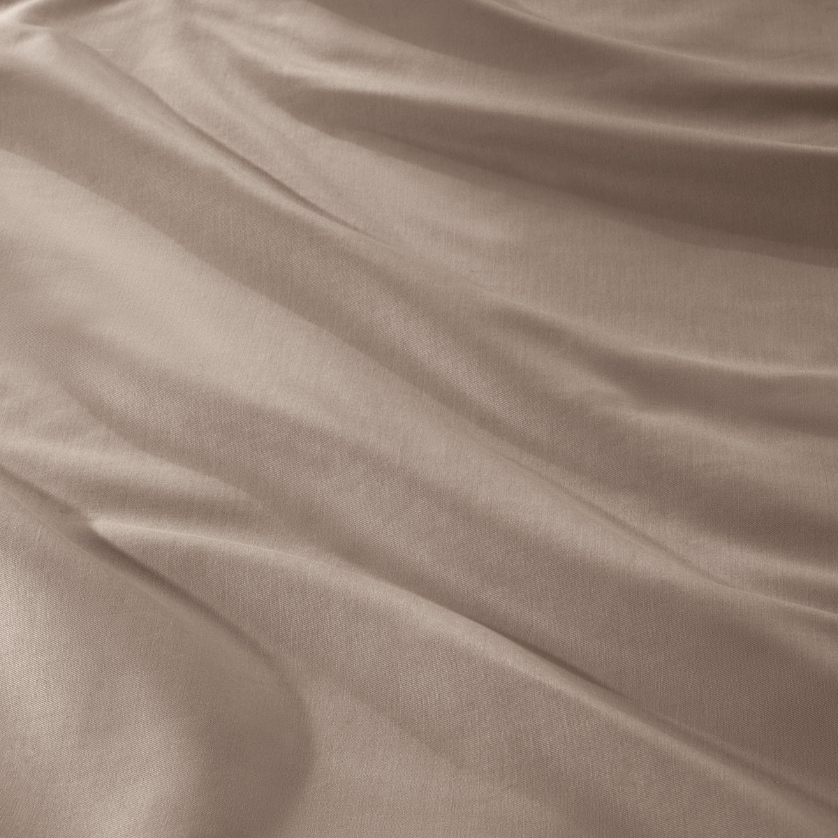 A close-up of draped sateen fabric with soft folds and a smooth texture.