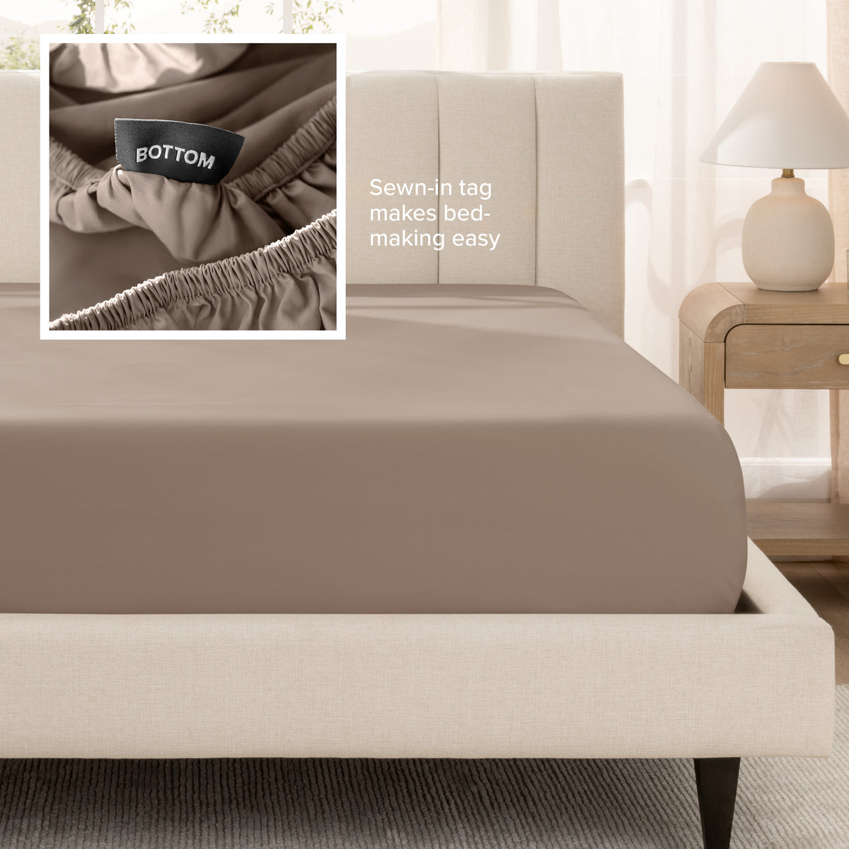 A fitted bed sheet shown on a bed. Text on the image says the sewn-in tag makes bed-making easy.