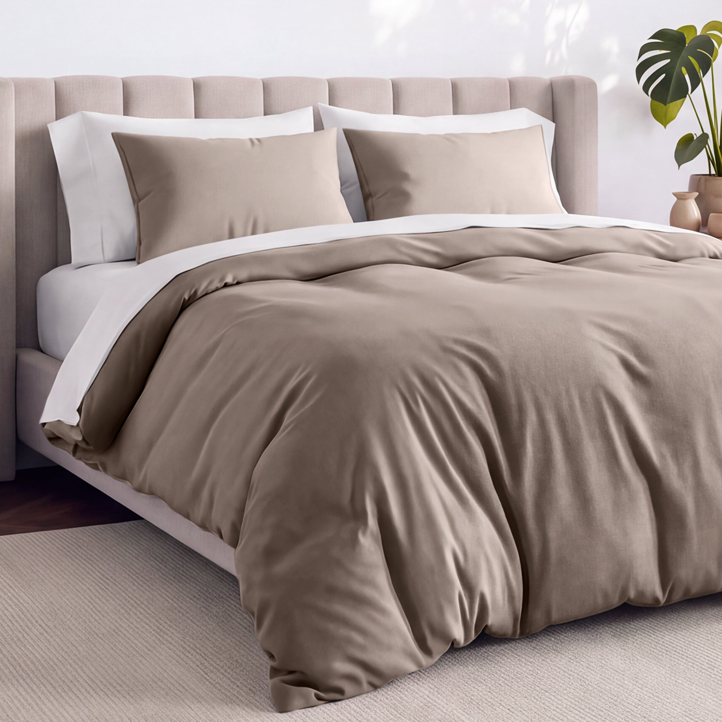 Bed with jersey duvet set against a beige headboard.