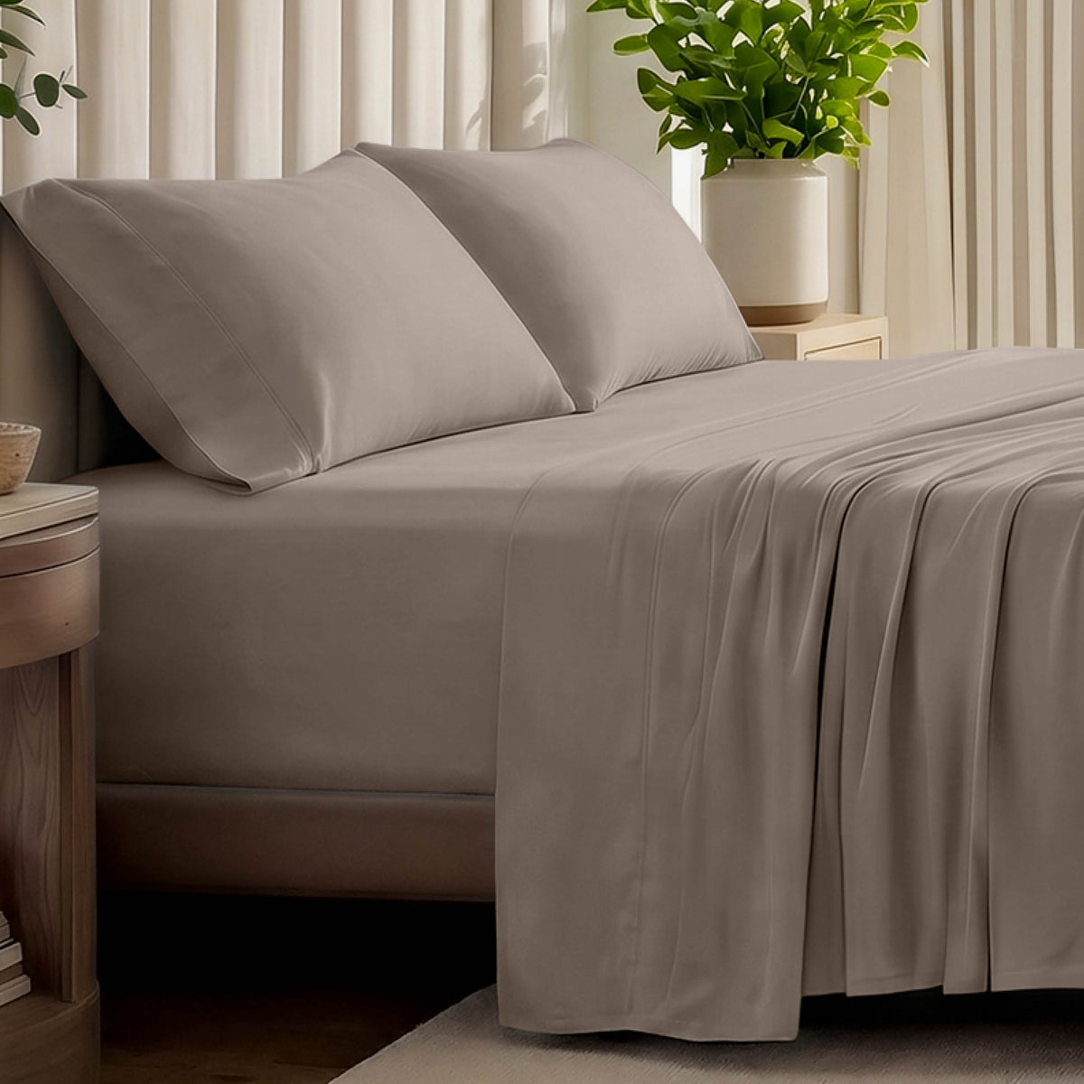 Organic jersey bed sheets and pillows on a bed with a wicker headboard.