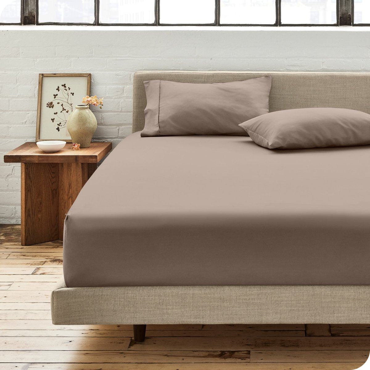 Modern bedroom with bed showing percale fitted sheet