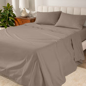 Percale sheets on a bed with a cream colored frame and headboard