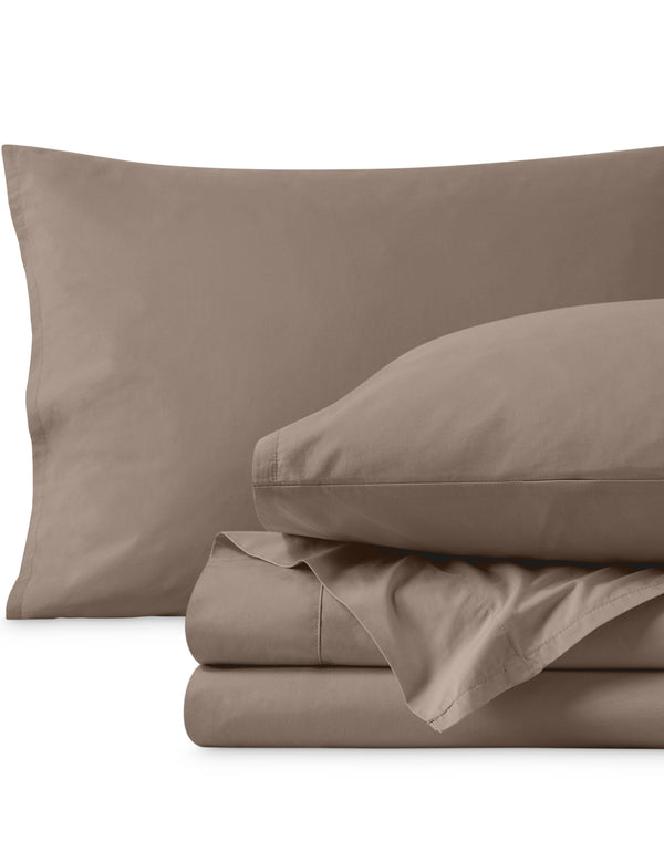 Percale sheets folded and matching pillowcases with pillows in them
