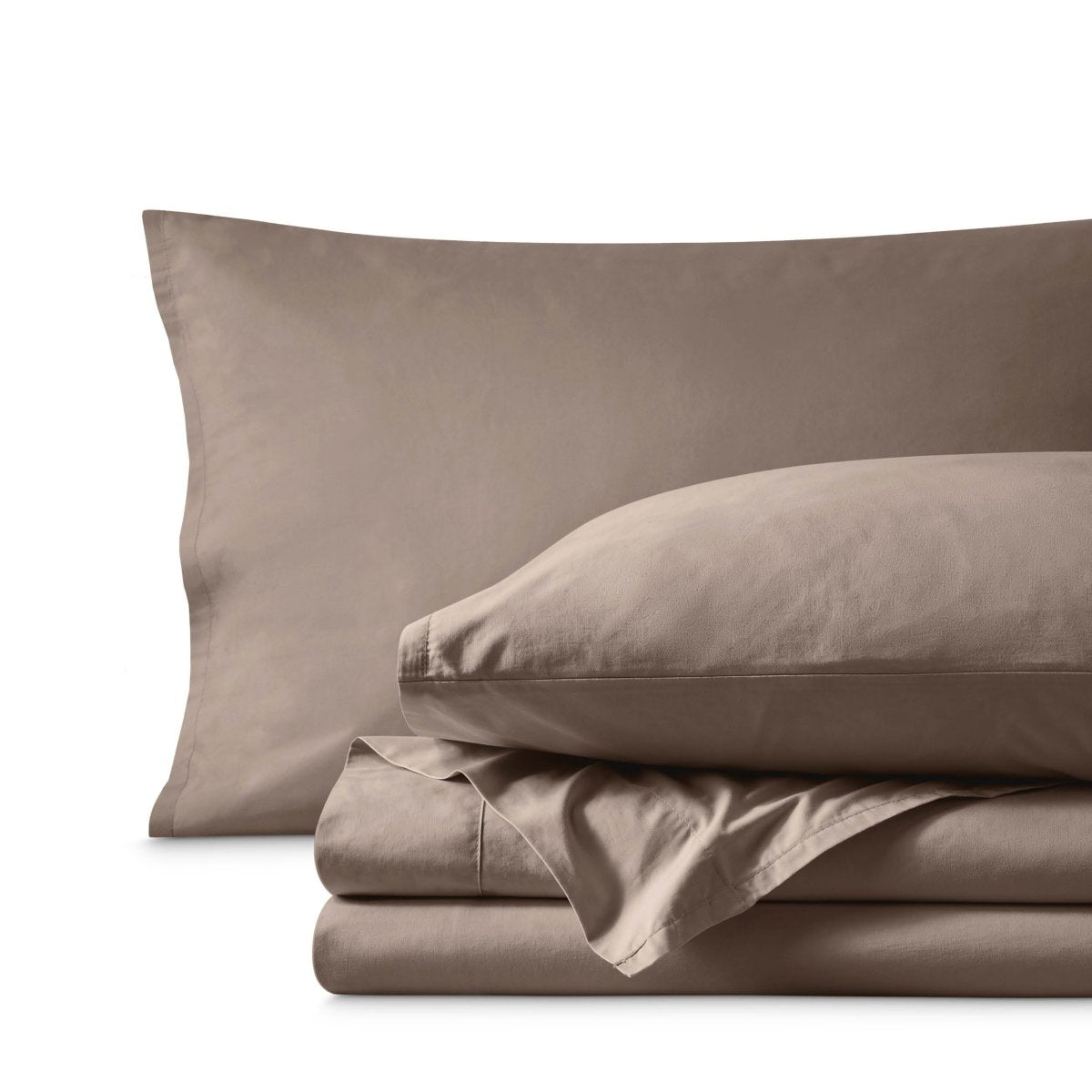 Percale bedding set including pillowcases and folded sheets arranged on a clean white background