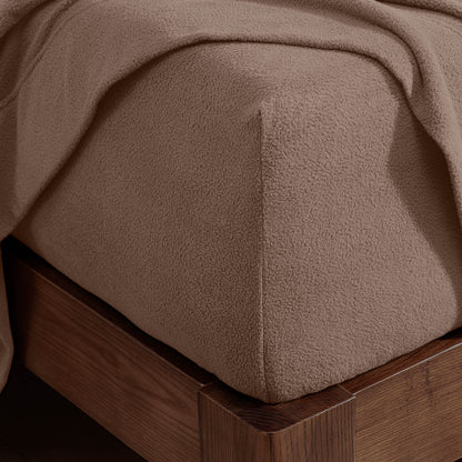 Corner of a mattress with a fitted sheet on it