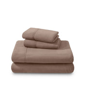 Polar fleece sheets and pillowcases folded and stacked on a white background