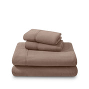 Polar fleece sheets and pillowcases folded and stacked on a white background