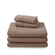 Polar fleece sheets and pillowcases folded and stacked on a white background