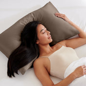 Woman lying on a bed with a pillow covered with a satin pillowcase