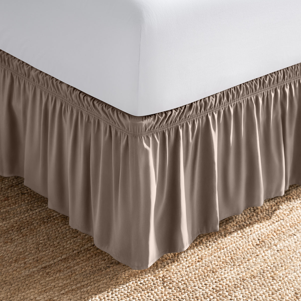 Bed with white fitted sheet and an adjustable bed skirt.