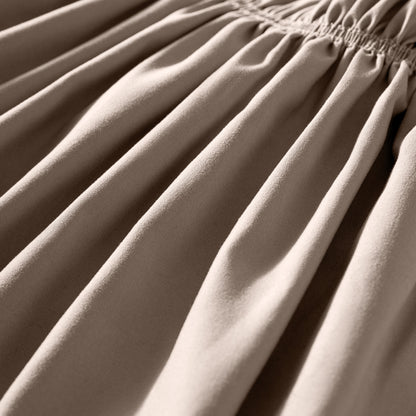 Close-up of polyester bed skirt fabric with a focus on texture and folds.