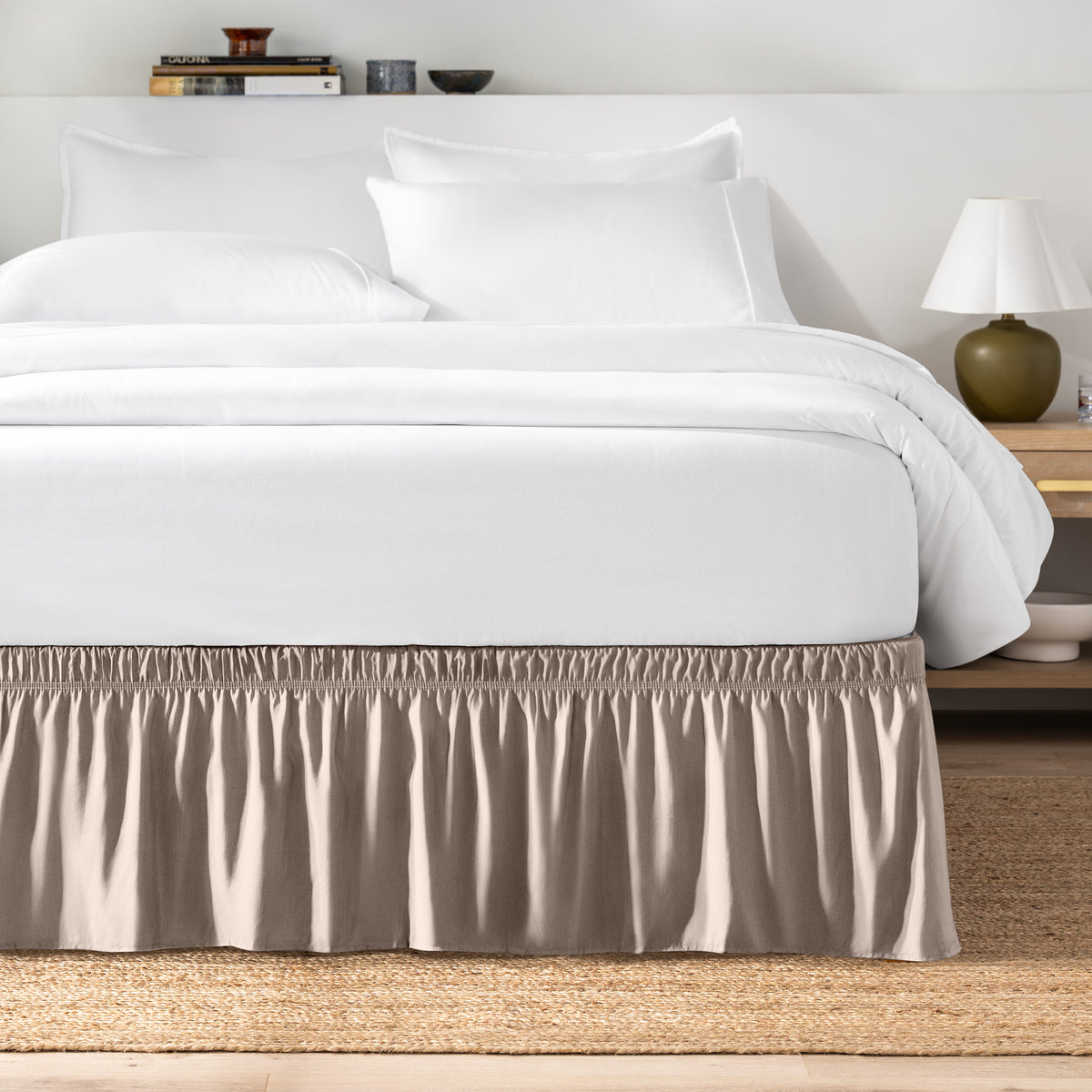 Bed with white bedding and a bed skirt.
