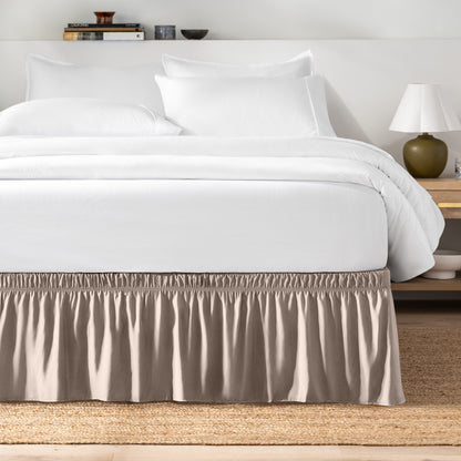 Bed with white bedding and a bed skirt.