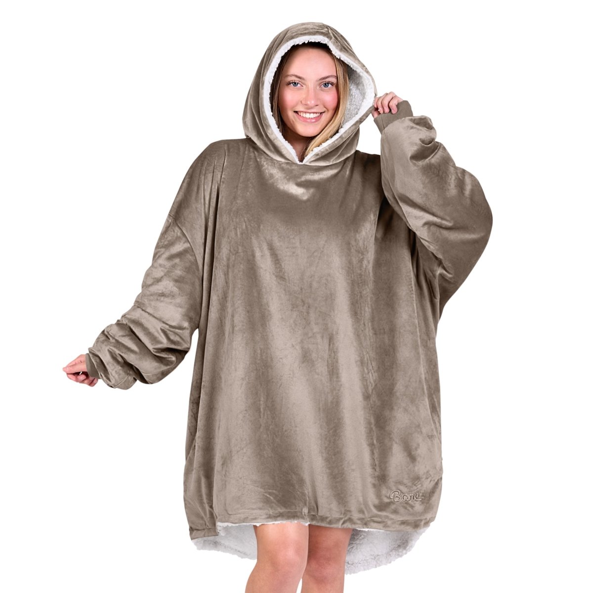 An adult with a hooded wearable blanket on