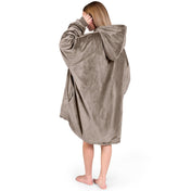 An adult with a sherpa wearable blanket on