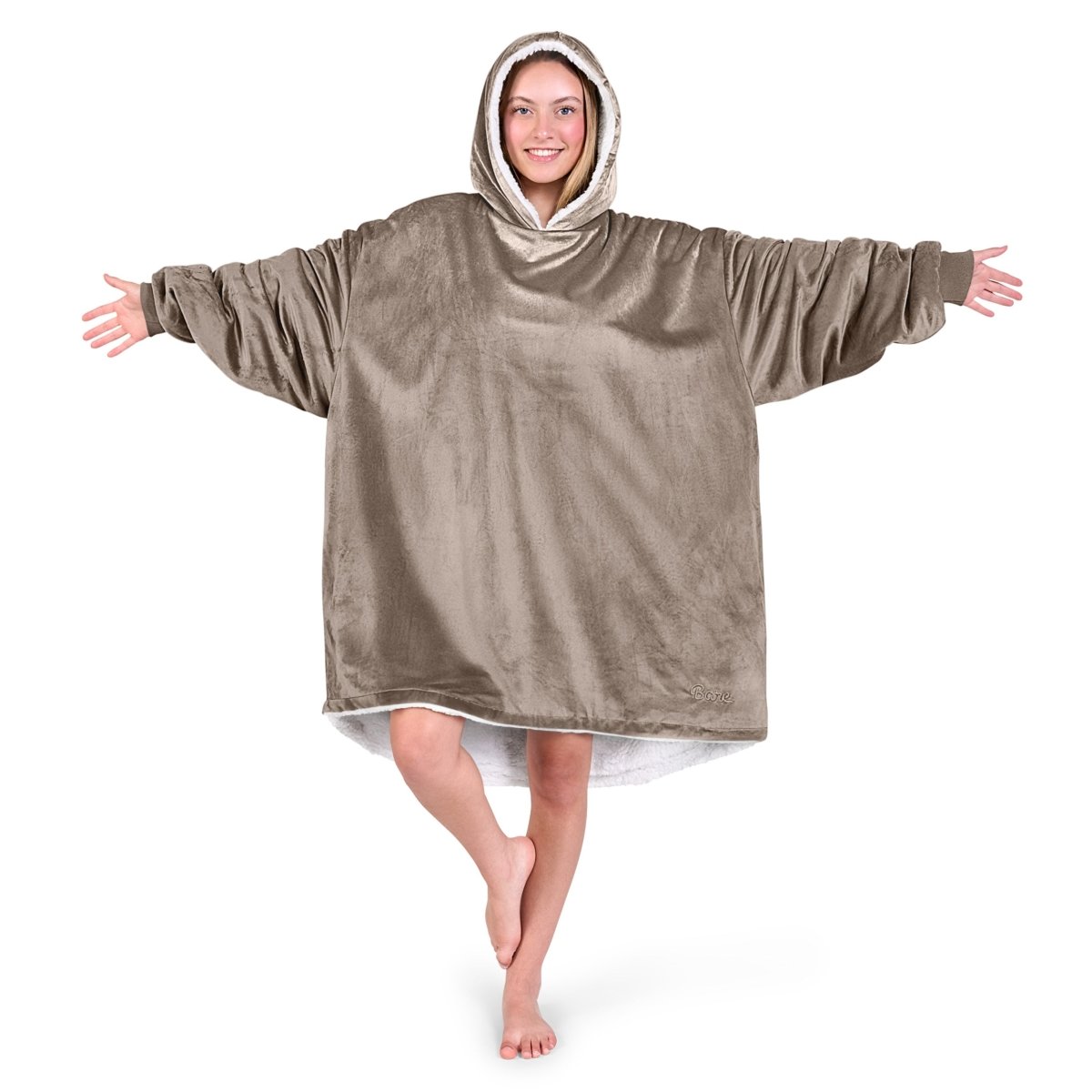 An adult with a hooded wearable blanket on