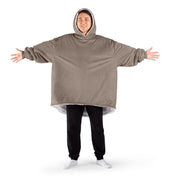 An adult with a sherpa wearable blanket on