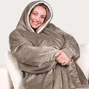 An adult with a sherpa wearable blanket on