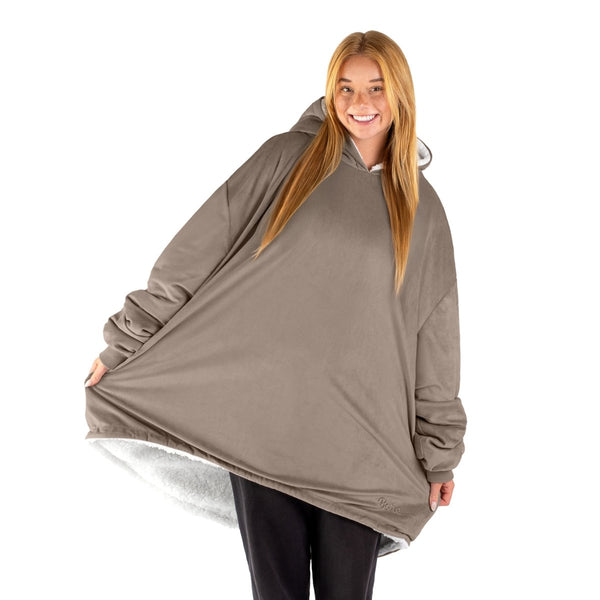 An adult with a sherpa wearable blanket on