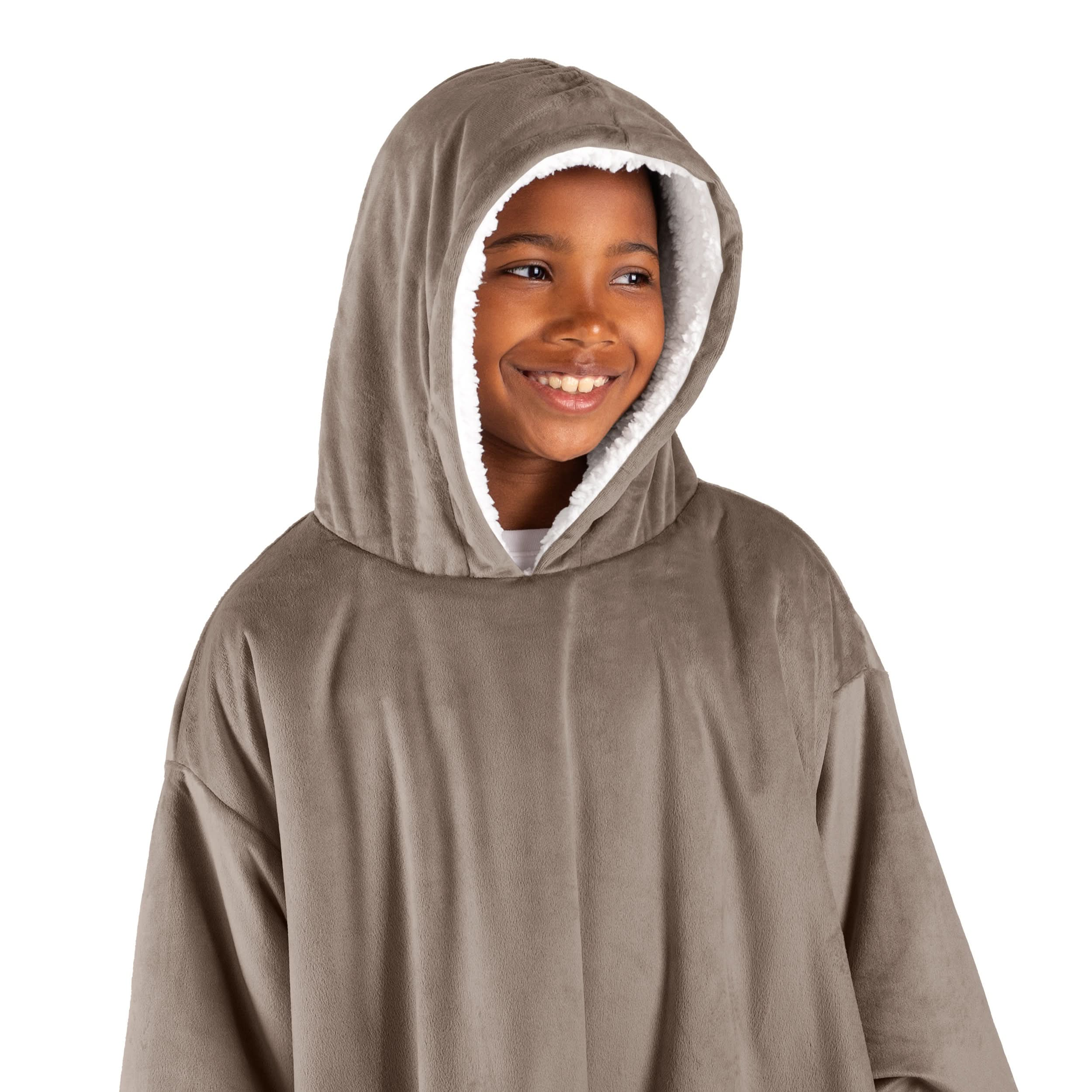 A boy with a wearable blanket on