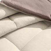 Close up of the reversible comforter showing the box stitching and the two colors