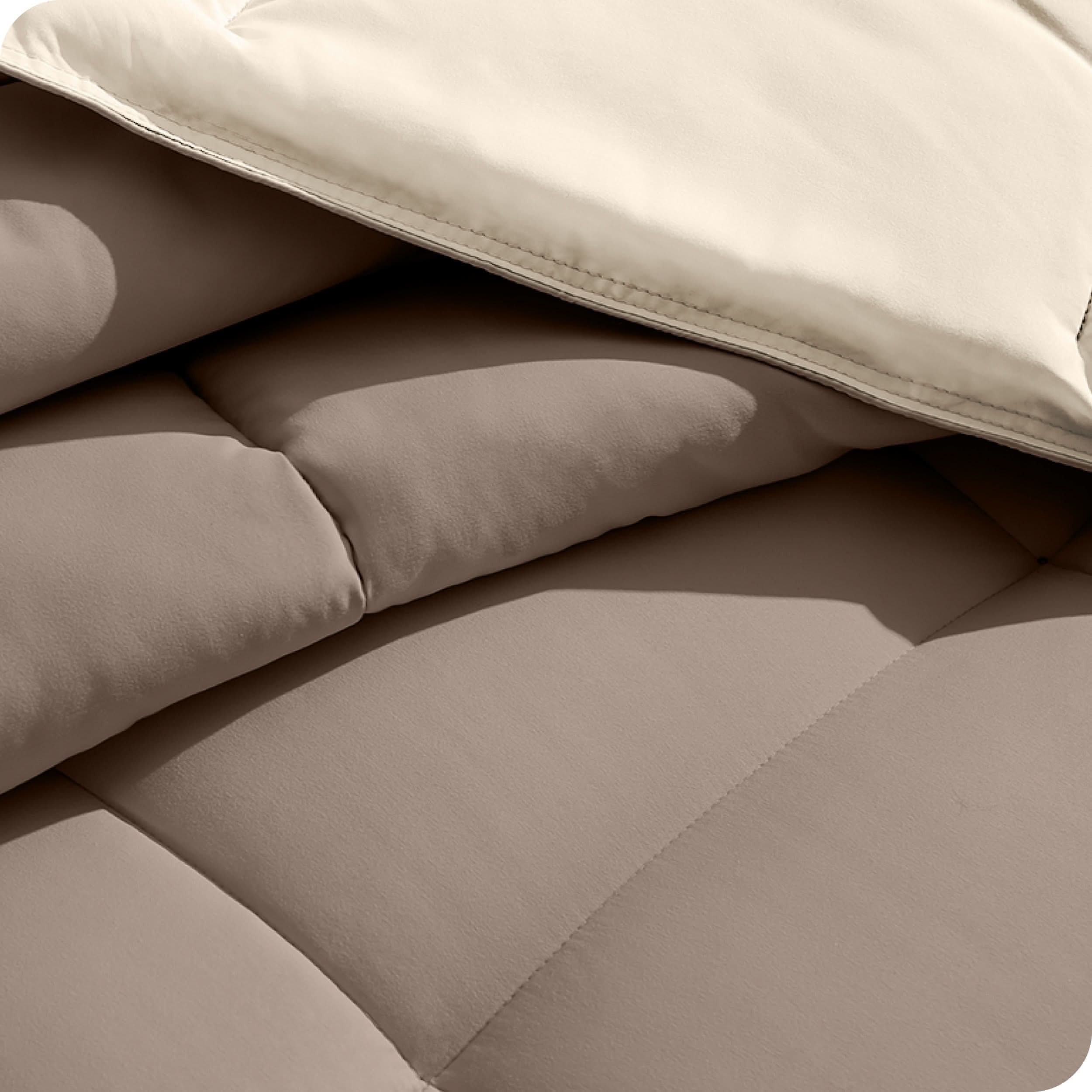 Close up of the reversible comforter showing the box stitching and the two colors