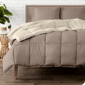 A wooden bed frame with a reversible comforter and sheet set on the mattress