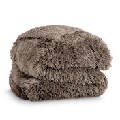 A shaggy faux fur blanket folded