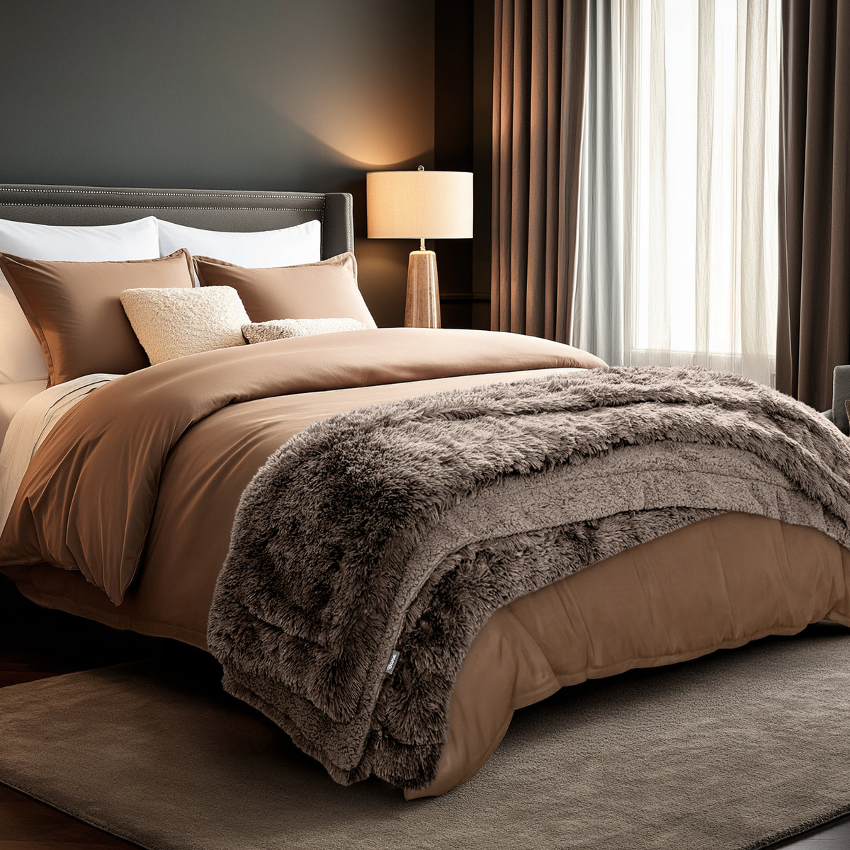 Neatly made bed and a textured throw blanket  over the end of the bed.