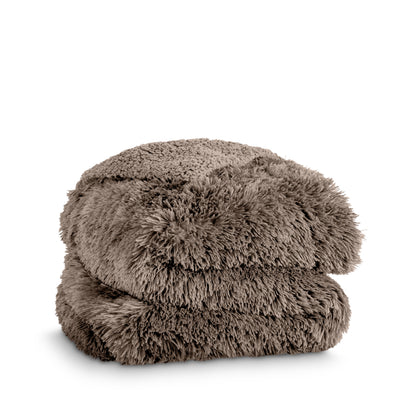 A shaggy faux fur blanket folded