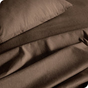 Close up of a heather sheet set on a bed