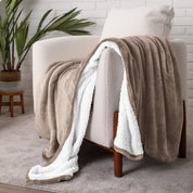 Blanket draped over a chair in a cozy living room setting.