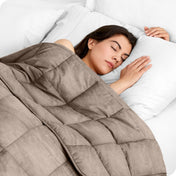 A woman sleeping with a weighted blanket over her body
