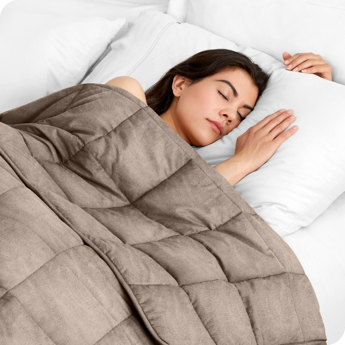 A woman sleeping with a weighted blanket over her body