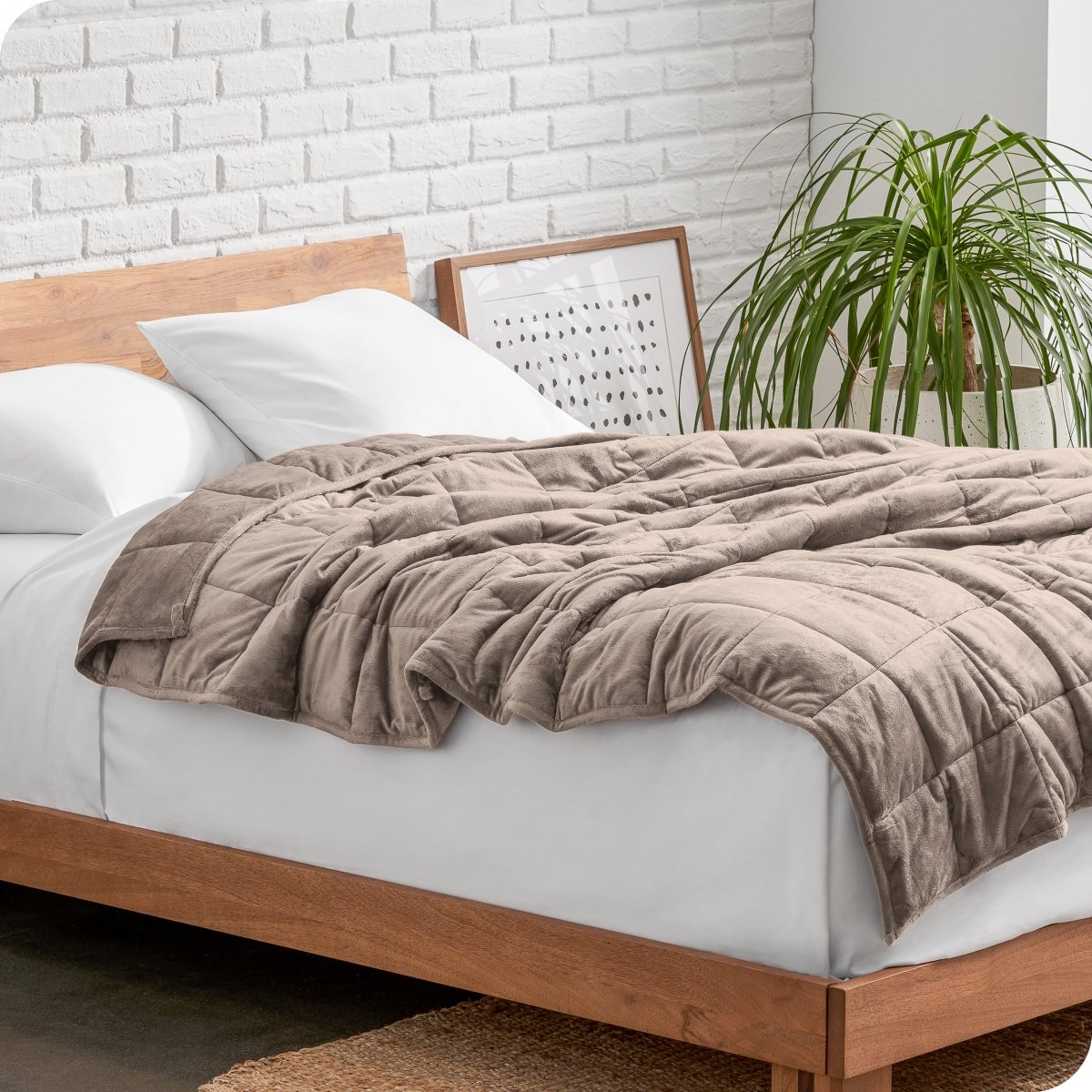 A weighted blanket draped over a bed