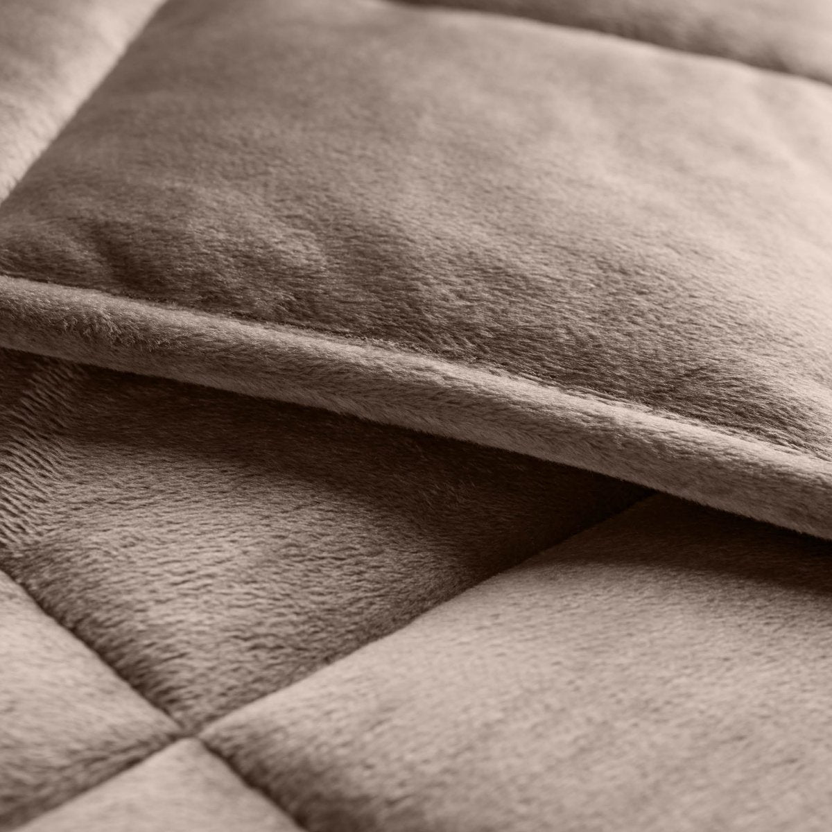 Close-up of a weighted blanket showing the stitching and texture