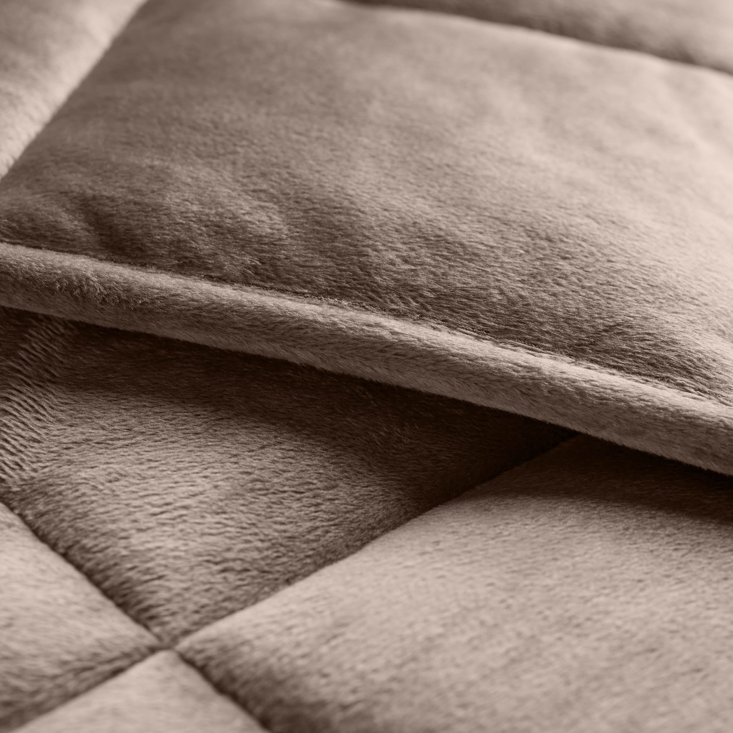 Close-up of a weighted blanket showing the stitching and texture