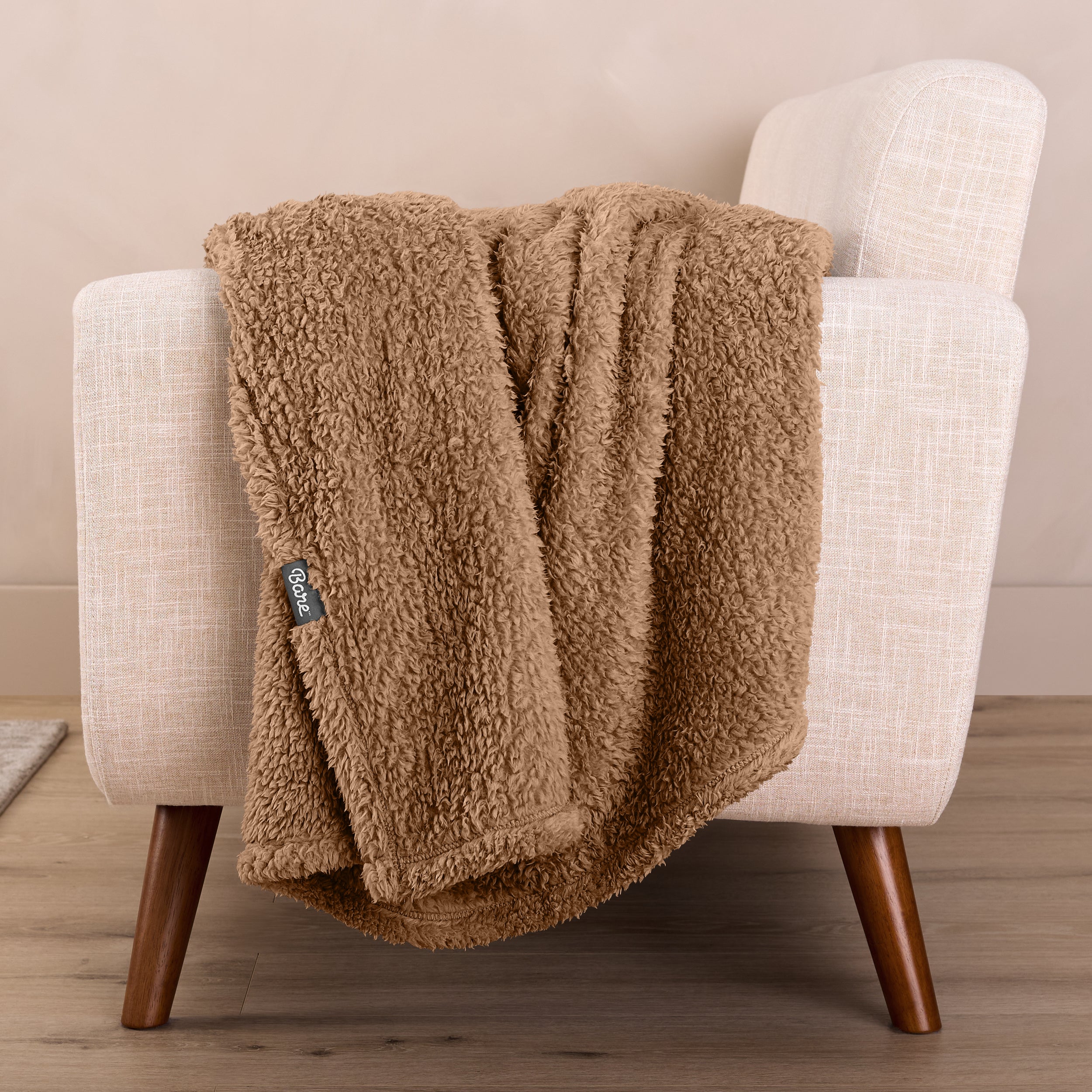 A sherpa blanket draped over a chair