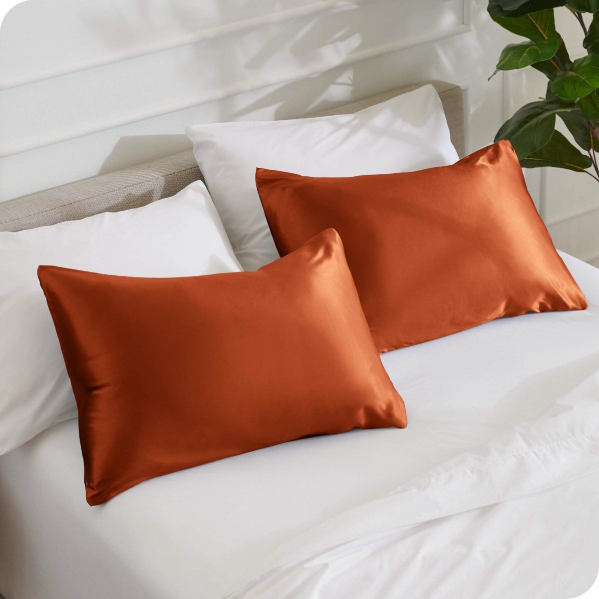 2 mulberry silk pillowcases on pillows set on a bed