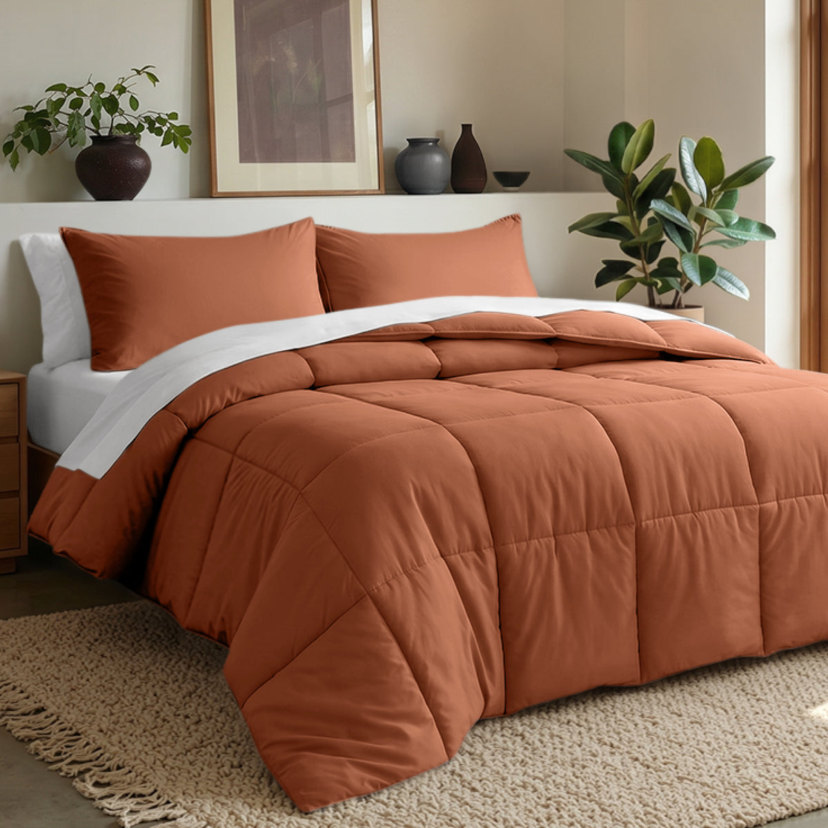 Comforter set on a bed in a bedroom with plants and decor.