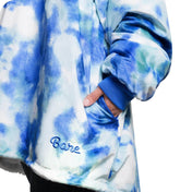An adult with a sherpa wearable blanket on