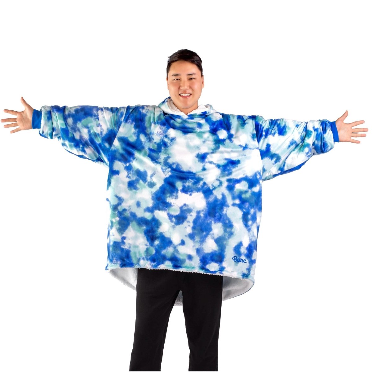 An adult with a sherpa wearable blanket on