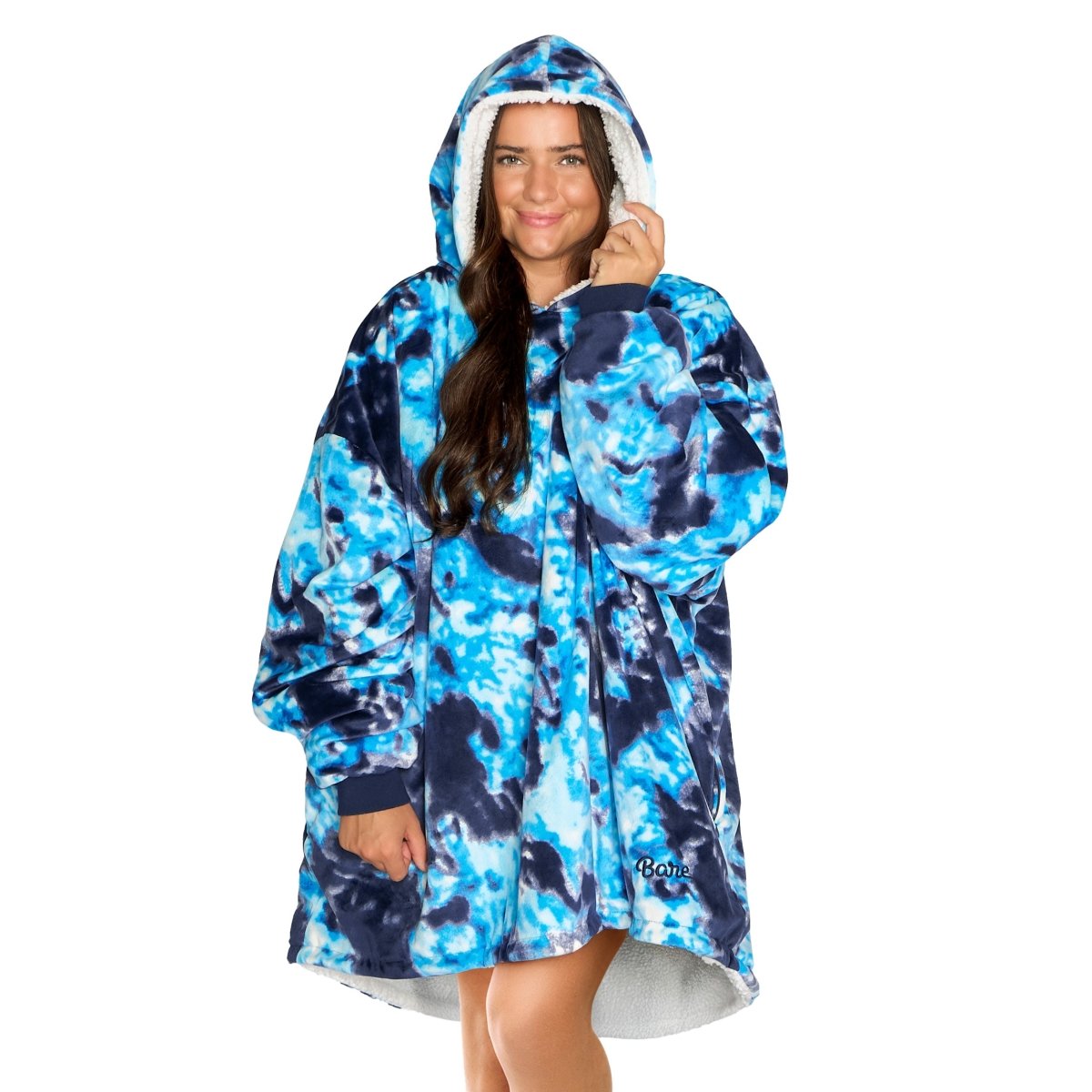 An adult with a sherpa wearable blanket on