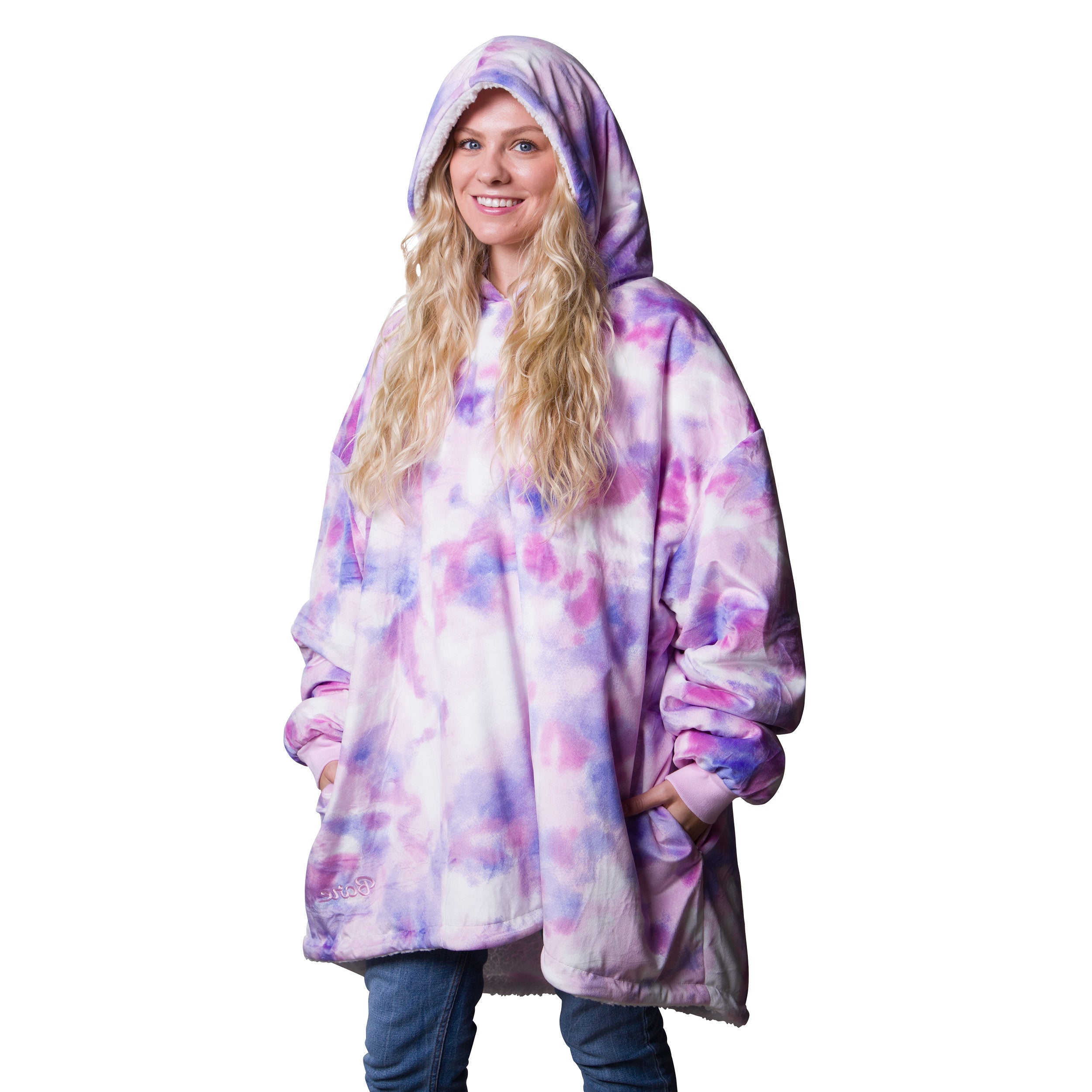 A oversized printed sherpa wearable blanket with a hood on a woman.